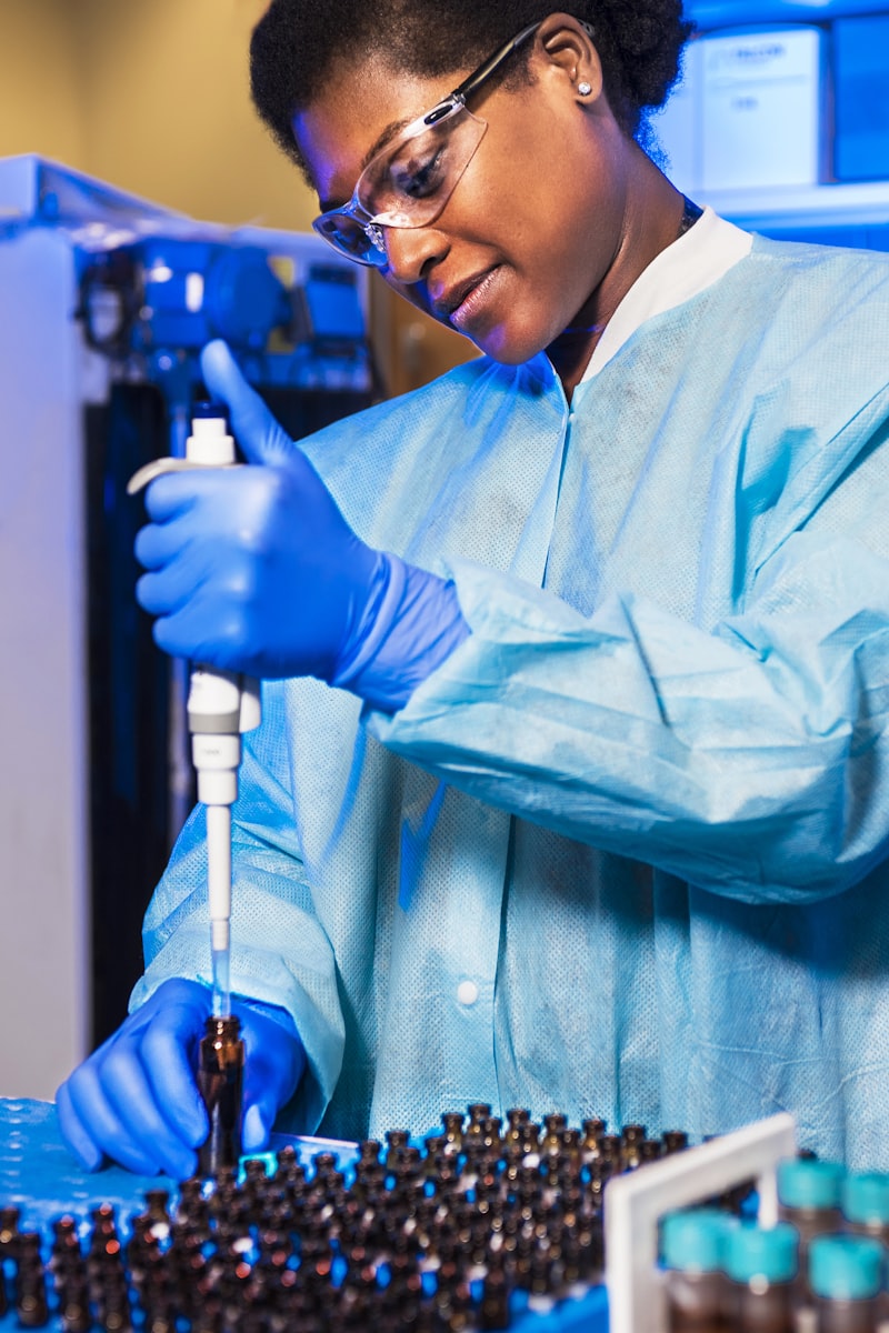 Scientist using a pipette in a pharmaceutical laboratory